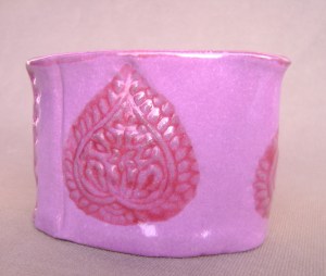 Fuchia mini creamer, with  deep red tear drop stamped design.